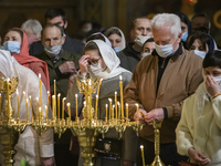 Orthodox believers in protective face masks take part in the Easter Liturgy in the St Michael's Golden-Domed Cathedral in Kyiv, Ukraine, on...