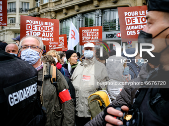 France Insoumise activists watch the procession pass under police escort. The traditional May Day demonstration in Paris gathered several th...