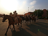 Security personnel mounted on horses conduct a flag march flag march to create awareness against the spread of the coronavirus during the Lo...