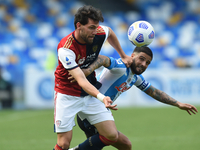 Arturo Calabresi of Cagliari Calcio competes for the ball with Lorenzo Insigne of SSC Napoli during the Serie A match between SSC Napoli and...