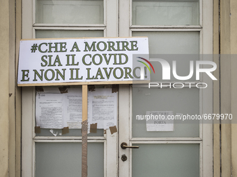 A sign reading 'Che a morire sia il Covid non il lavoro' (Let Covid die, not work) during a demonstration by workers in the tourism sector i...