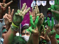 Supporters of Trinamool Congress (TMC) party celebrate their party's lead in the West Bengal state legislative assembly elections during the...