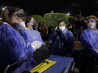Medical personnel are ready to attend to people after a structure of the Metro Line 12 in Mexico City between Tezonco and Olivos stations co...