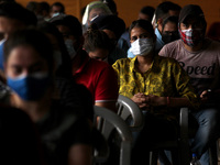 People wearing protective gears wait to receive a dose of COVISHIELD, a coronavirus (COVID-19) vaccine manufactured by Serum Institute of In...