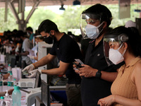 People wearing protective gears register to receive a dose of COVISHIELD, a coronavirus (COVID-19) vaccine manufactured by Serum Institute o...
