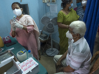   A health care officer is inoculating a dosage of Bharat Biotech's Covaxin vaccine during the mass vaccination drive.On May 4, 2021 in Kolk...