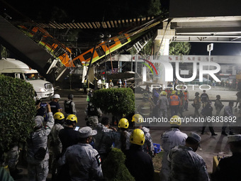  A member of rescue squad  is seen during the rescue the bodies of the victims where Mexico City subway olivos station overpass collapsed, k...