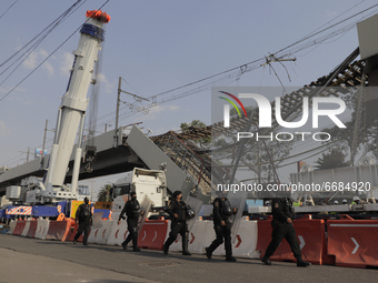 Police officers guard the affected area after the collapse of a column on Line 12 of the Metro Collective Transport System in Mexico City be...