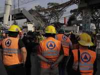 Civil Protection workers supervise the affected area after the collapse of a column on Line 12 of the Metro Collective Transport System in M...
