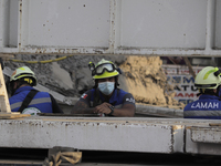 Rescuers in the affected area after the collapse of a column on Line 12 of the Metro Collective Transport System in Mexico City between Tezo...