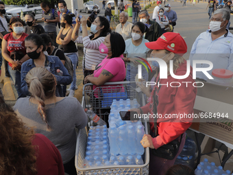 Residents of the Tláhuac district are waiting to share food with rescuers, clean-up workers, reporters and photographers in the affected are...