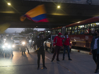 A person waves a Colombian flag in Bogota. In the national strike that completes seven days, people protesting against the government of Col...