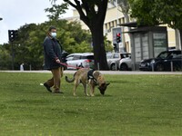 A person wearing a protective mask walks with his pet around Alameda Park. Lisbon, May 03, 2021. Portugal is slowly returning to normality a...