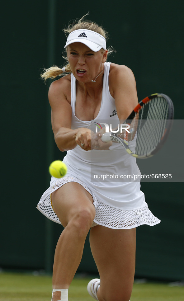 (150702) -- WIMBLEDON, July 2, 2015 () -- Denmark's Caroline Wozniacki returns a shot during the lady's second round against Denisa Allertov...