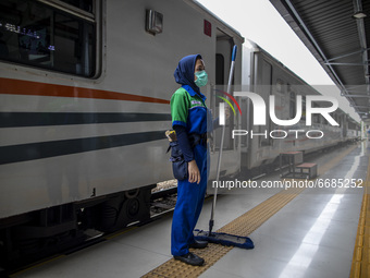A  woman train cleaning service ready for serve at the station in Jakarta, Indonesia, on 05 May 2021. People filled in senen station, jakart...