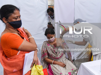 Women gets vaccine against COVID-19 coronavirus disease, at a vaccination centre in Guwahati, India on 05 May 2021. India has opened up vacc...
