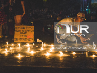 Protesters gather to paid tribute to the people who pass away at the protest with candles and flowers, rejecting the violence during a natio...