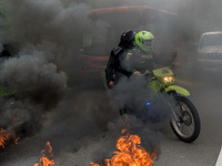 Police forces are seen as hundreds of people protest during the national strike in Colombia, after seven days of consecutive marches since l...