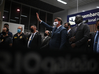 Brazil's President Jair Bolsonaro gestures to supporters before a press conference amidst the Coronavirus (COVID-19) pandemic at Galeao Airp...