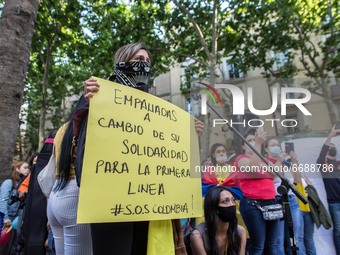 Protester is seen with a sign that says, empanadas in exchange for their solidarity for the first line S.O.S Colombia.
About 400 people, mos...