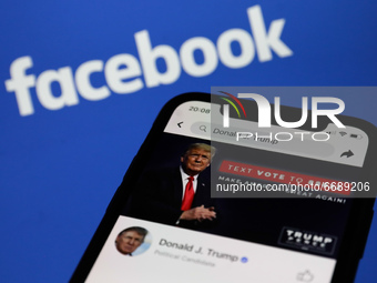 Donald Trump's Facebook account is seen displayed on a phone screen with Facebook logo in the background in this illustration photo taken in...