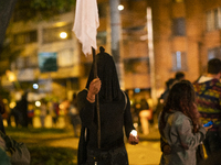 A person with a black veil in Bogota. For the ninth day, people in the capital came out to protest against the police abuse and the national...