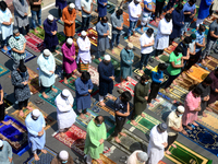 Bangladeshi Muslims offer Jummat-Ul-Vida prayers on the last Friday of the holy fasting month of Ramadan on the street in front of a Mosque...