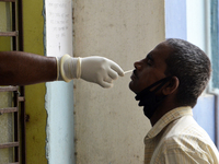 A man reacts during his swab test amid coronavirus emergency in Kolkata, India, ob 7 May, 2021. India records 4.14 lakh fresh covid-19 cases...