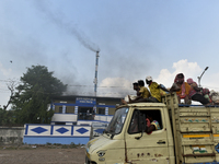 Workers travel by a mini truck, passes by an electric crematorium center amid coronavirus emergency in Kolkata, India, ob 7 May, 2021. India...