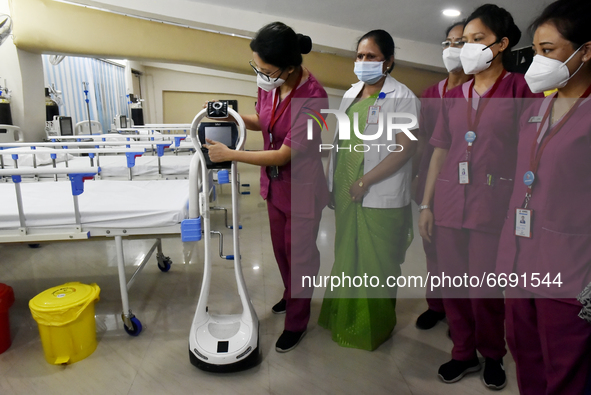 Health workers give demo of a machine where a covid patient can talk to a doctor through this machine in a temporary converted covid care un...