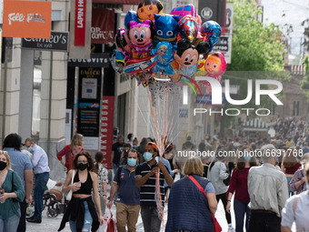 A man seen holding balloons at Ermou street in the center of Athens, Greece on May 7, 2021. (