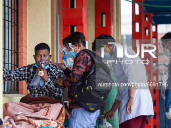 A Covid-19 patient receives oxygen outside an emergency ward of a government hospital in Kathmandu, Nepal on Friday, May 7, 2021.  As the se...