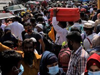 Migrant workers get into an overcrowded ferry to reach home to celebrate Eid-Ul-Fitr during a government imposed lockdown amid Covid-19 Pand...