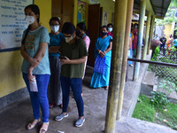Beneficiaries over 18 years of age wait in a queue to receive COVID-19 doses, at a centre in Nagaon District of Assam, india on May 8, 2021....