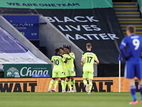 Joe Willock of Newcastle United celebrates with teammates after scoring the opening goal of the match during the Premier League match betwee...