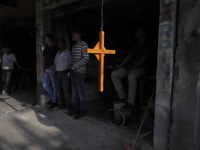 A cross hangs outside an establishment on Avenida Tláhuac near the collapse of Metro line 12 on the night of May 3 between Tezonco and Olivo...