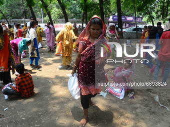 Homeless people carries relief material after receive during a government-imposed nationwide lockdown as a preventive measure against the CO...