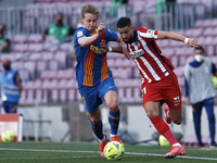 Frenkie de Jong of Barcelona and Yannick Carrasco of Atletico Madrid compete for the ball during the La Liga Santander match between FC Barc...