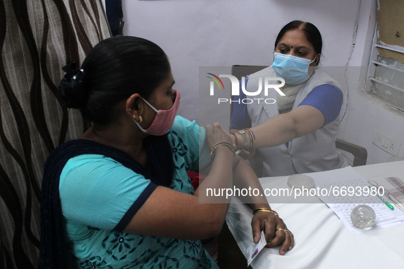 A healthcare worker gives a dose of COVAXIN, a coronavirus (COVID-19) vaccine manufactured by Bharat Biotech, at a vaccination centre, in Ne...
