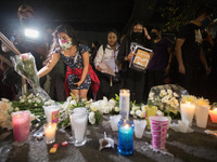 Persons deposit candles and white flowers in crash site  in  memory of the victims that lost their lives due the Mexico City metro overpass...