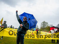 Hundreds of people are holding huge banners and placards, during the national demonstration against wind turbines near homes and in nature r...