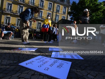 Posters condemning the violence in Colombia lie on the ground during a rally in Luis de Camões square, Lisbon. 08 May 2021. Colombians in Po...