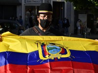 A protester holds an Ecuadorian flag in support of the demonstrators during a rally in Luis de Camões square, Lisbon. 08 May 2021. Colombian...