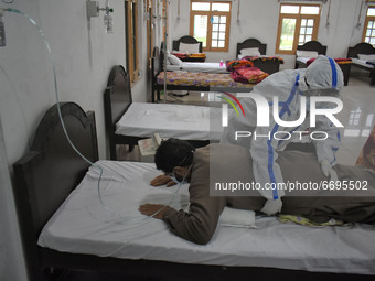 A Health worker helps a Covid-19 patient with breathing exercise at a temporary Covid-19 hospital in Srinagar, Indian Administered Kashmir o...