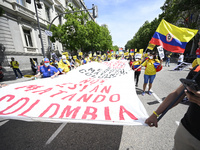 A protester carrying a placard and wearing a Colombian flag during a demonstration in support of Colombian people and against violence in th...
