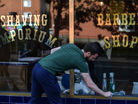 A man cleans the window of a Barber Shop in Dublin city center before it reopens on Monday next. 
On Saturday, 8 May 2021, in Dublin, Irelan...