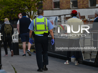 A member of Garda seen in Dublin's Portobello area checking if any Covid-19 legislation breaches and remining the public that it is still un...