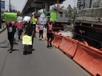 Activists demonstrate in the emergency zone where on Monday night, May 3, a column collapsed between the Tezonco and Olivos stations in Mexi...