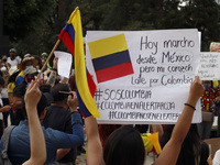 Persons hold  Colombian flags while joins a demonstration at Monument of Revolution to protest against the repression and killings in Colomb...