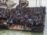 Crowds of people waits for a ferry as they want to travel back home ahead of the Muslim festival Eid al-Fitr at Shimulia ferry ghat in Munsh...